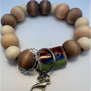 Wristlet/keychain made out wood beads with one ceramic bead.